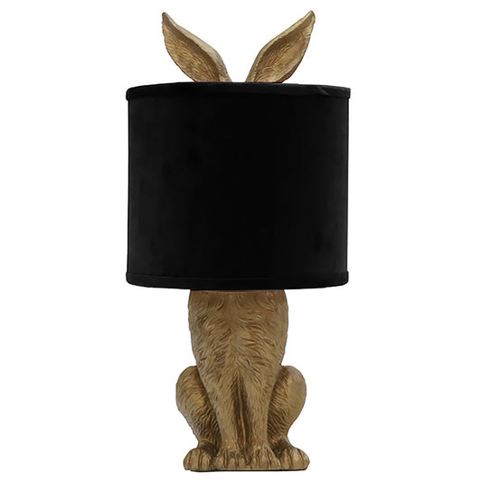 Table lamp with gold resin bunny ears and base and classic black shade.